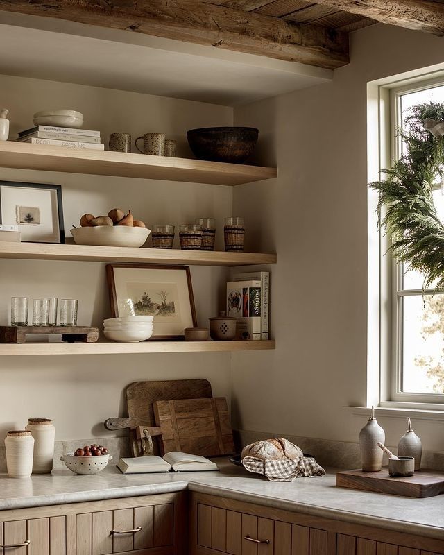 a kitchen with wooden cabinets and shelves filled with dishes