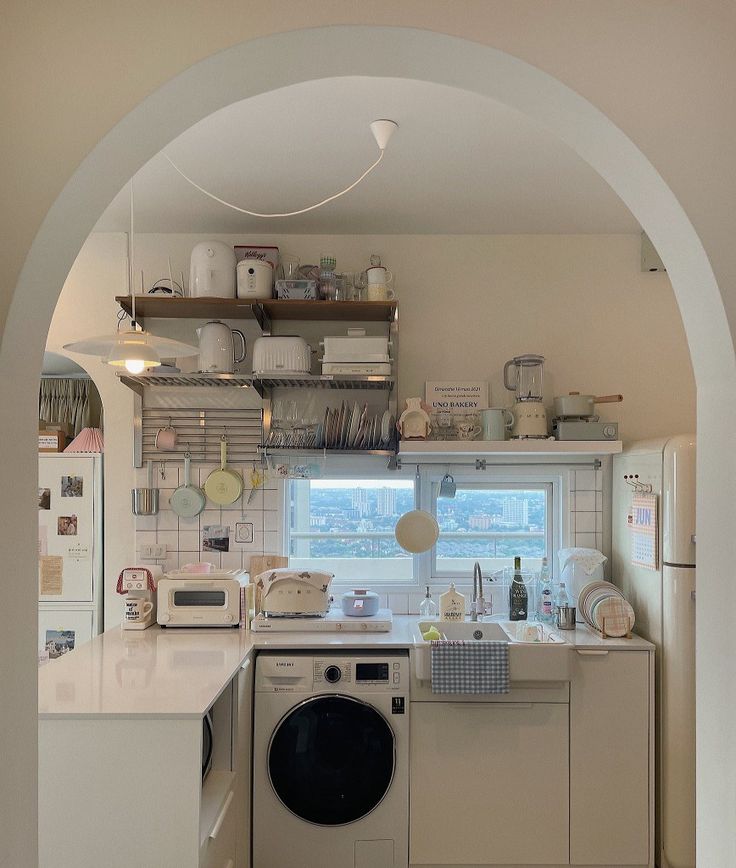 a kitchen with a washer and dryer in it