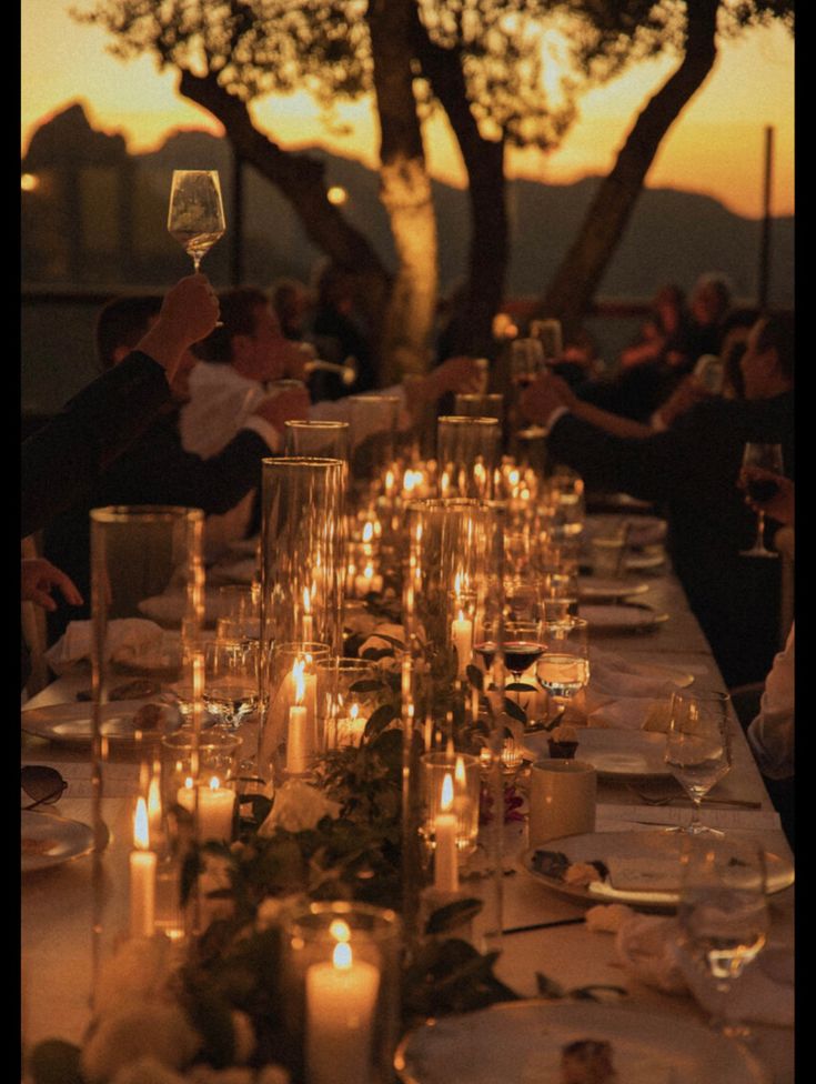 a long table is set with candles and plates