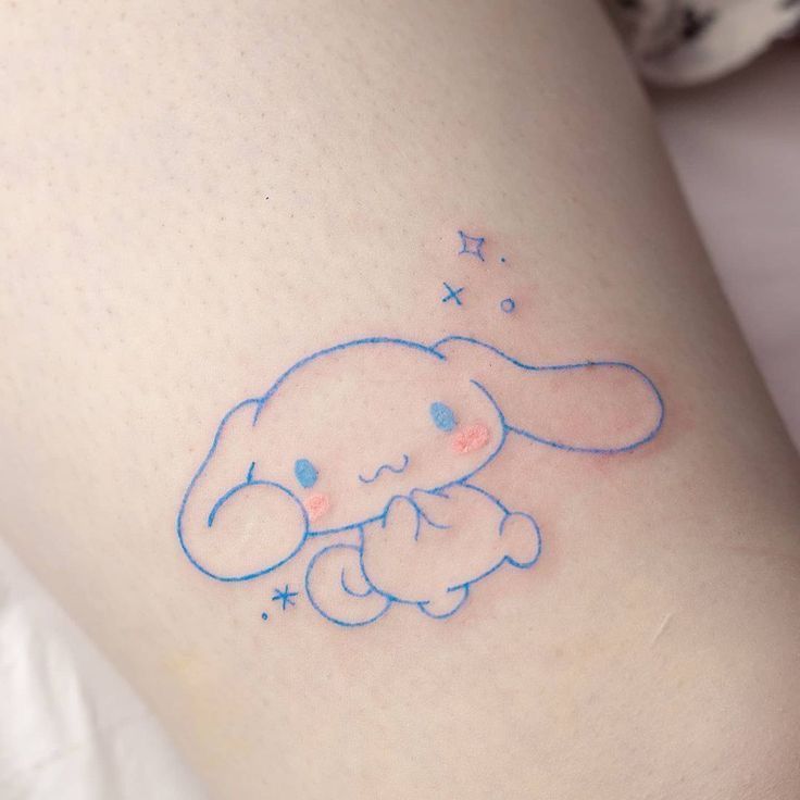 a small blue elephant tattoo on the leg