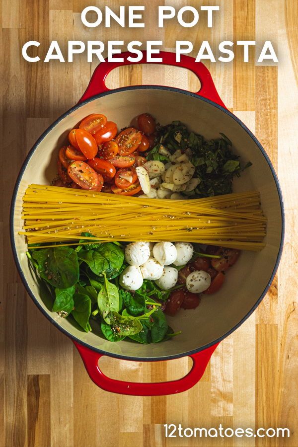 one pot caprese pasta with tomatoes, spinach and other vegetables in it