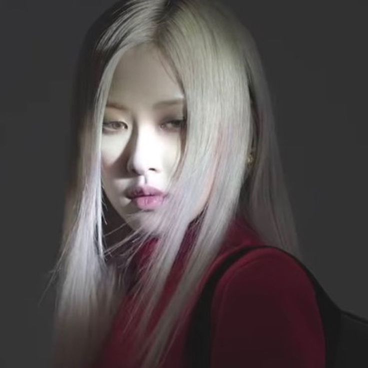 a woman with long white hair and pink lips