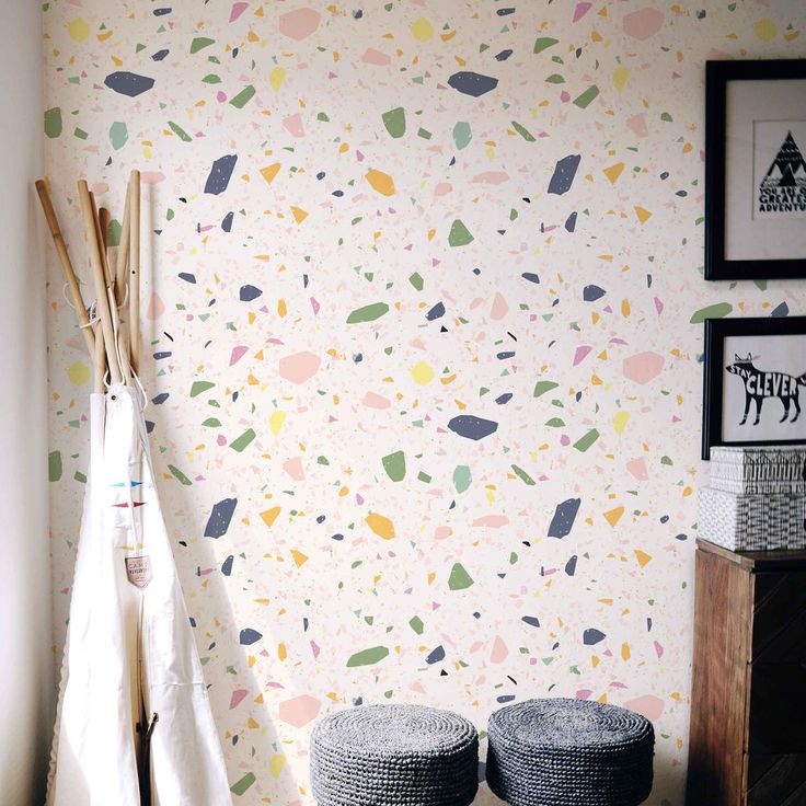 two baskets sitting on the floor in front of a wall