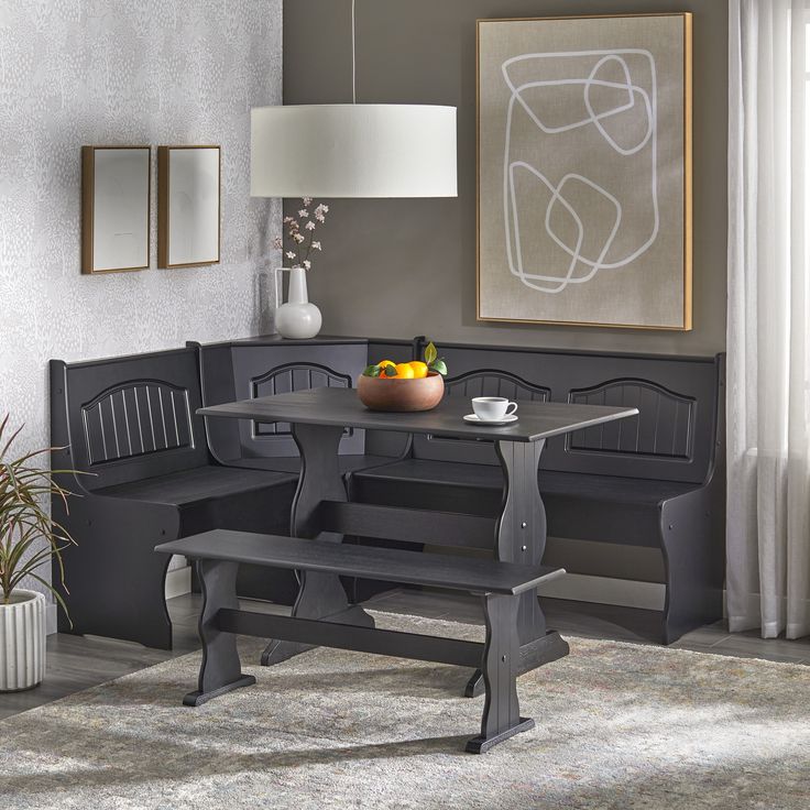 a dining room table with two benches and a bowl of fruit on the plate next to it