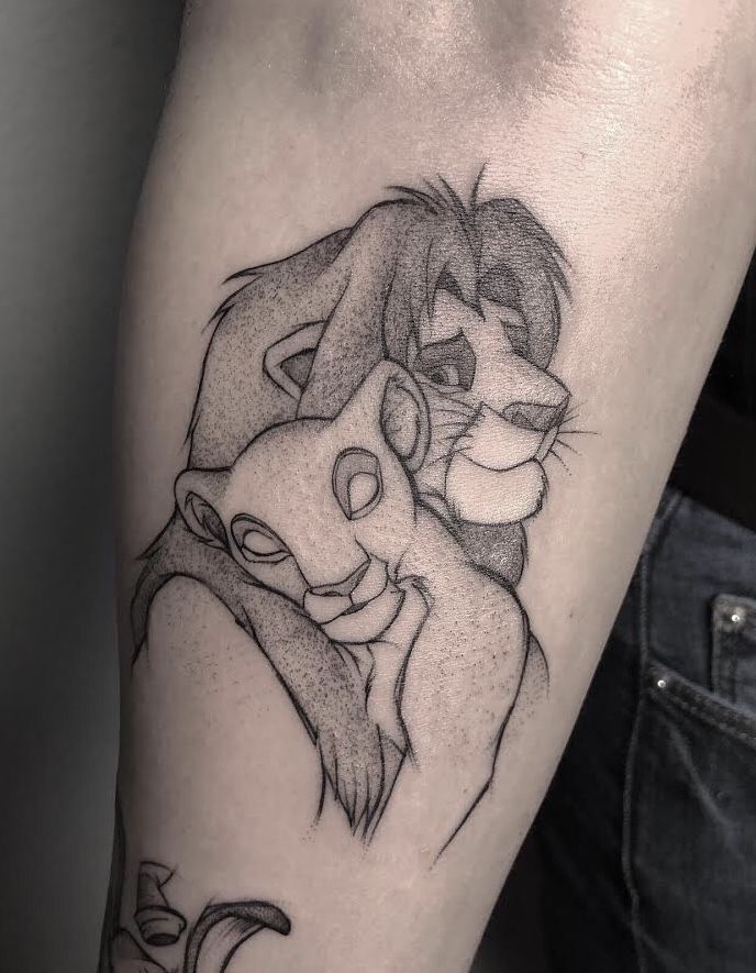 a lion and cub tattoo on the arm