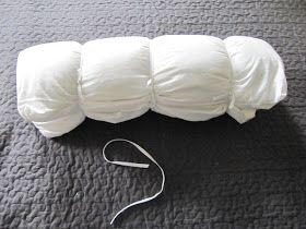 four pillows are laying on the floor next to a white cord and an electric device