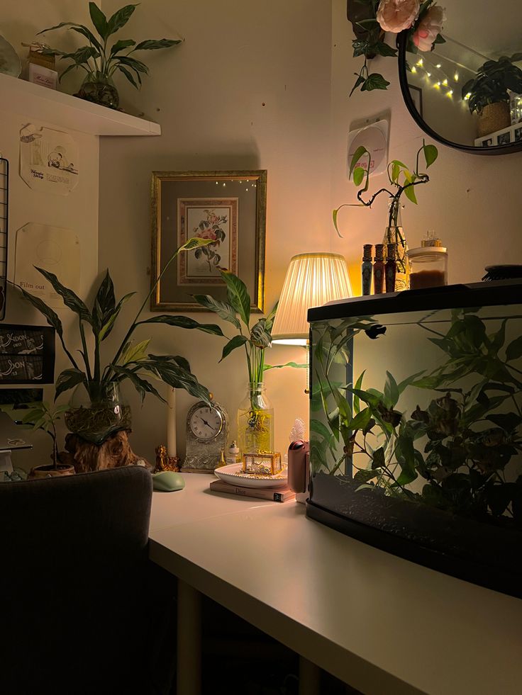 a living room with plants on the wall and a fish tank in front of it