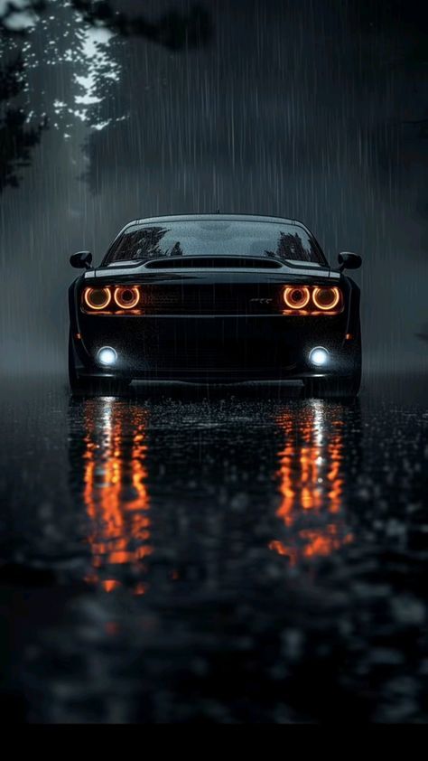 a black sports car in the rain with its headlights turned on and it's headlamps glowing