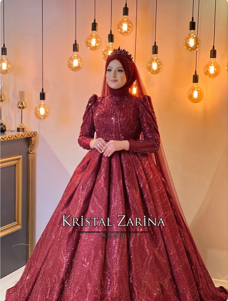 a woman in a red wedding dress standing next to some lights