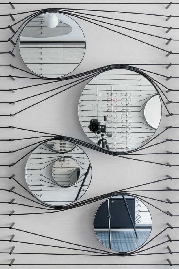 three circular mirrors hanging on the wall