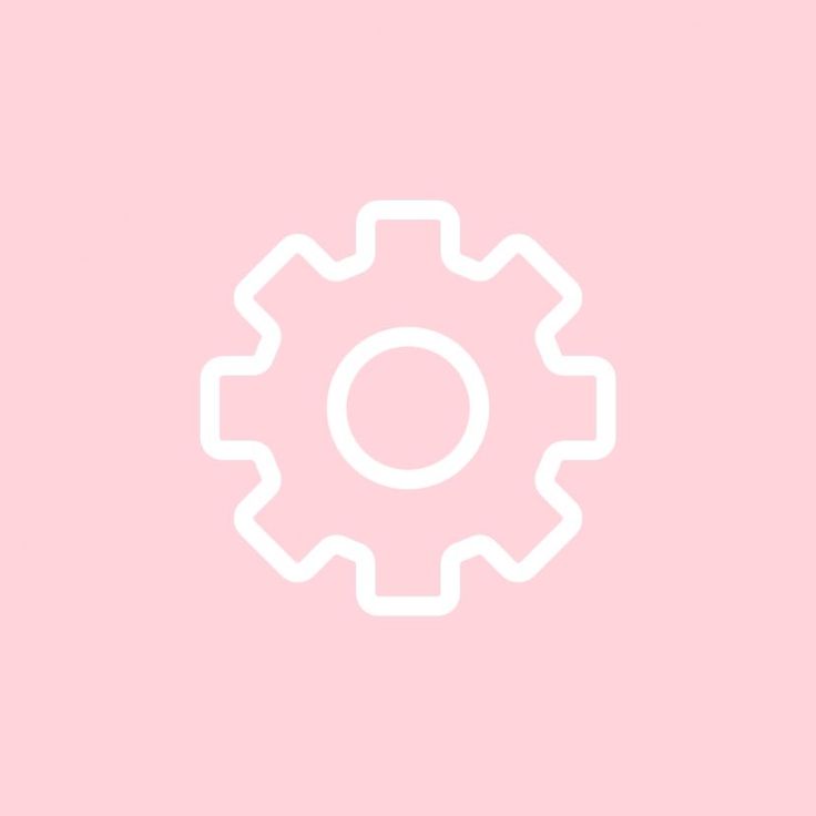 a white gear wheel on a pink background