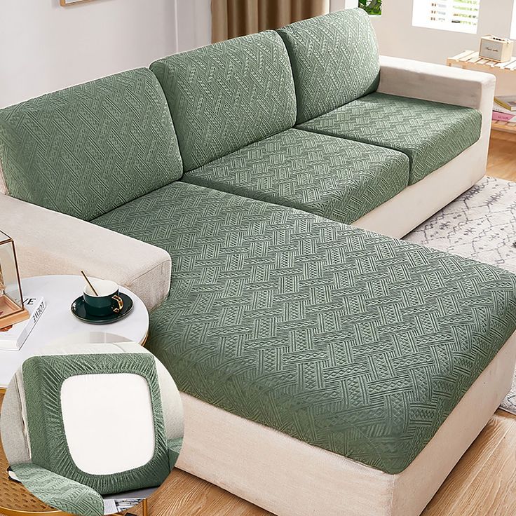 a living room with a green couch and white coffee table in front of the couch