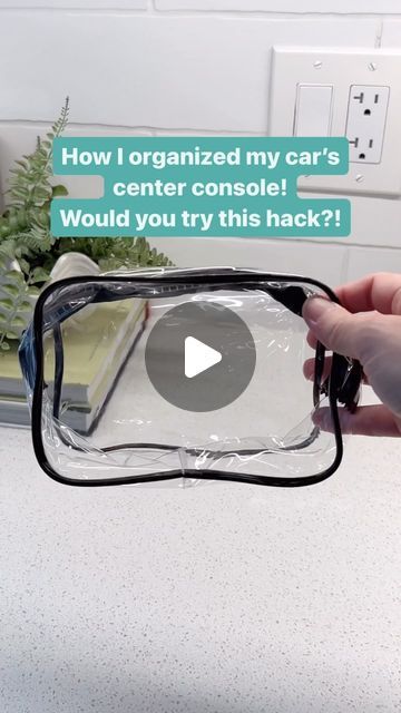 someone is holding up a clear case to show off their car's center console