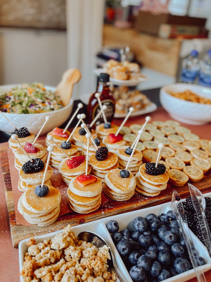 an assortment of desserts and snacks on a table in front of other food items