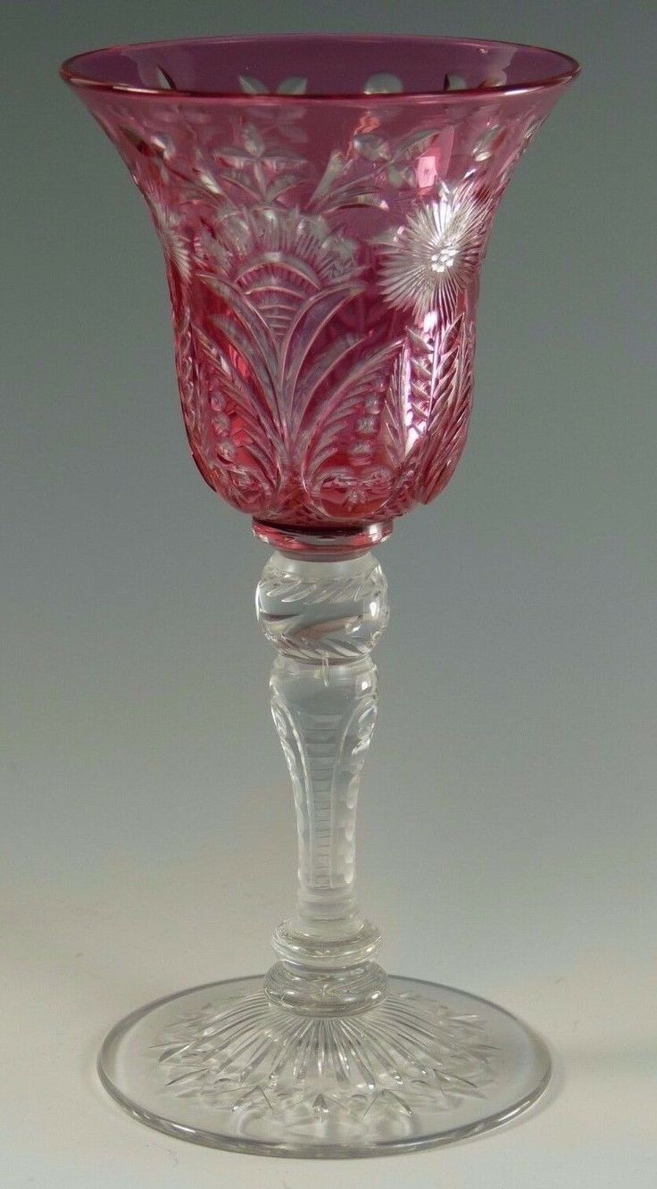 a pink glass vase sitting on top of a table