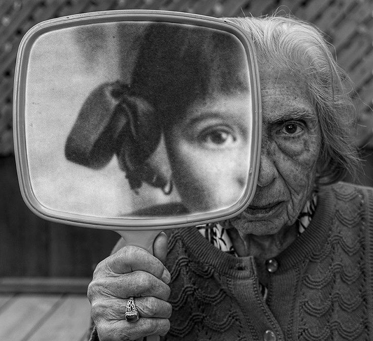 an old woman holding up a mirror with her face in it and the caption'life is not about waiting to die, it's about wanting to live