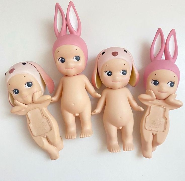 five little dolls with bunny ears standing next to each other