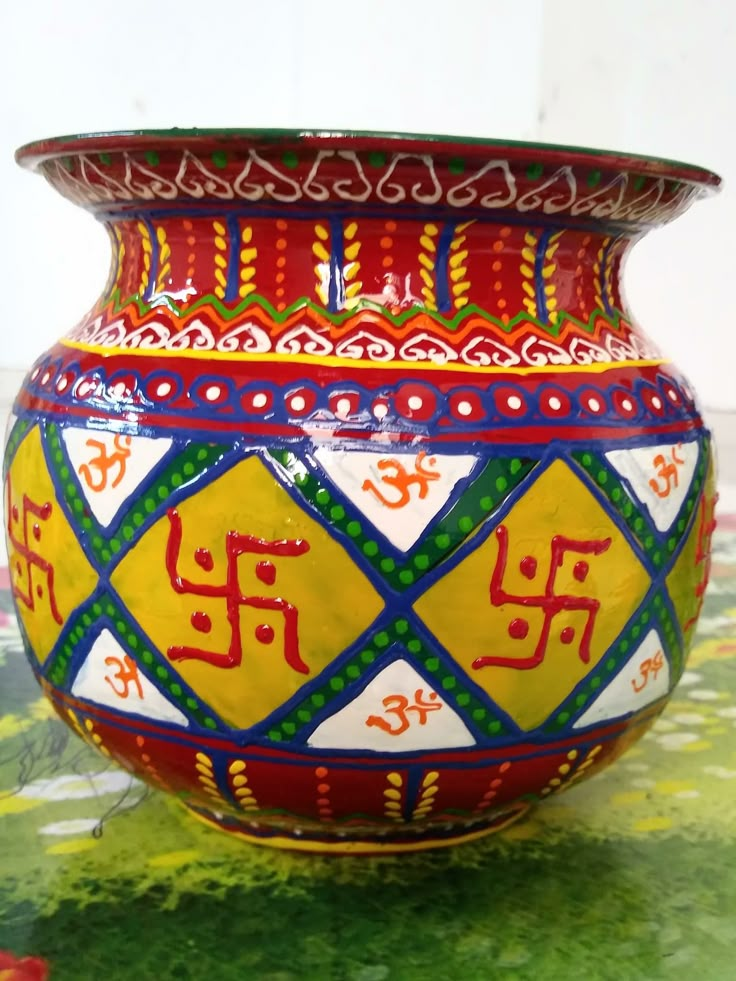 a colorful vase sitting on top of a table