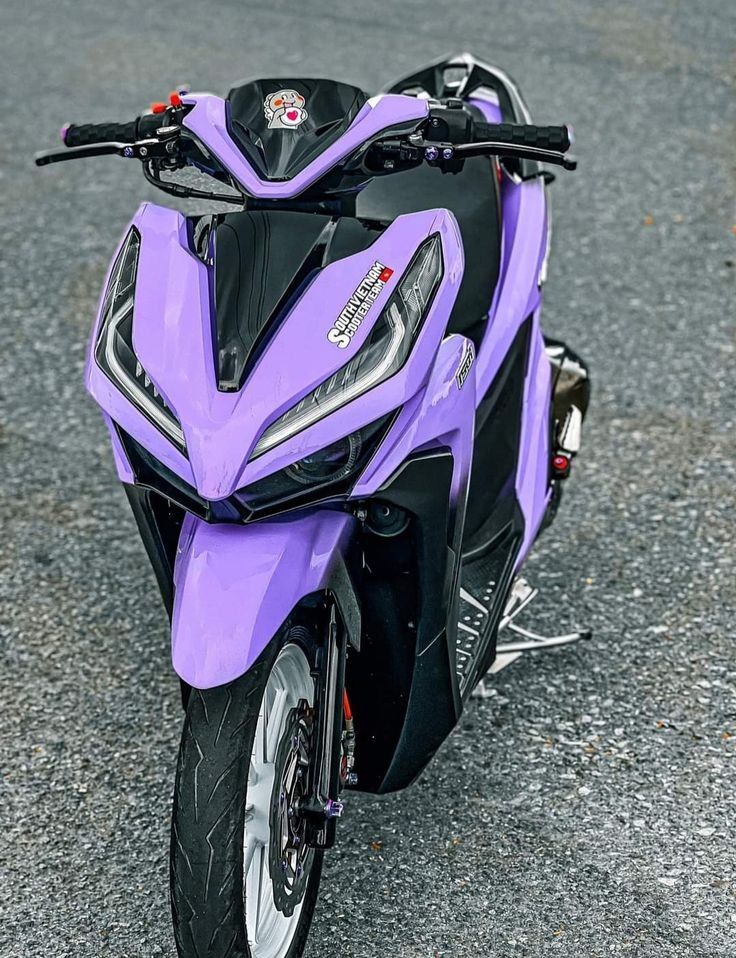 a purple motorcycle is parked on the street