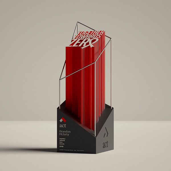 a red and black trophy with the words achievement on it's front side, sitting on a gray surface