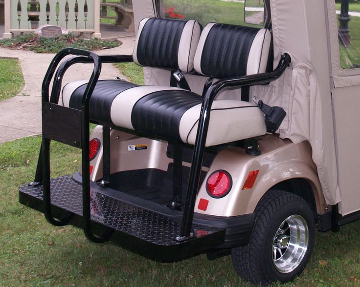 a golf cart with two seats on the back