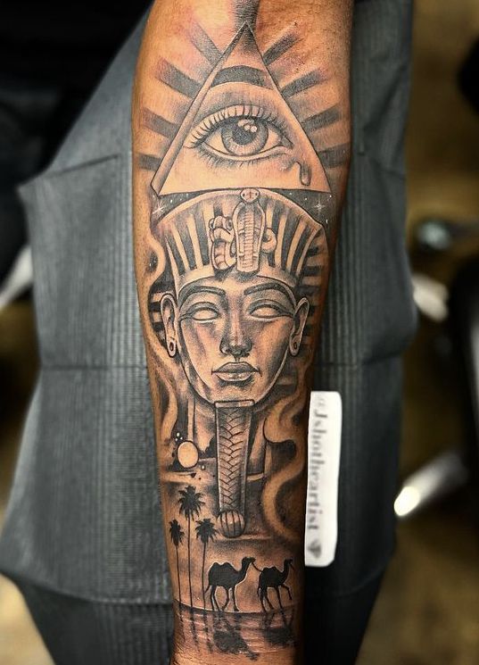 an egyptian tattoo design on the arm