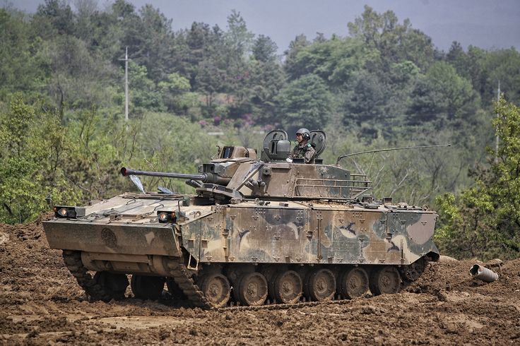 an army tank is driving through the mud