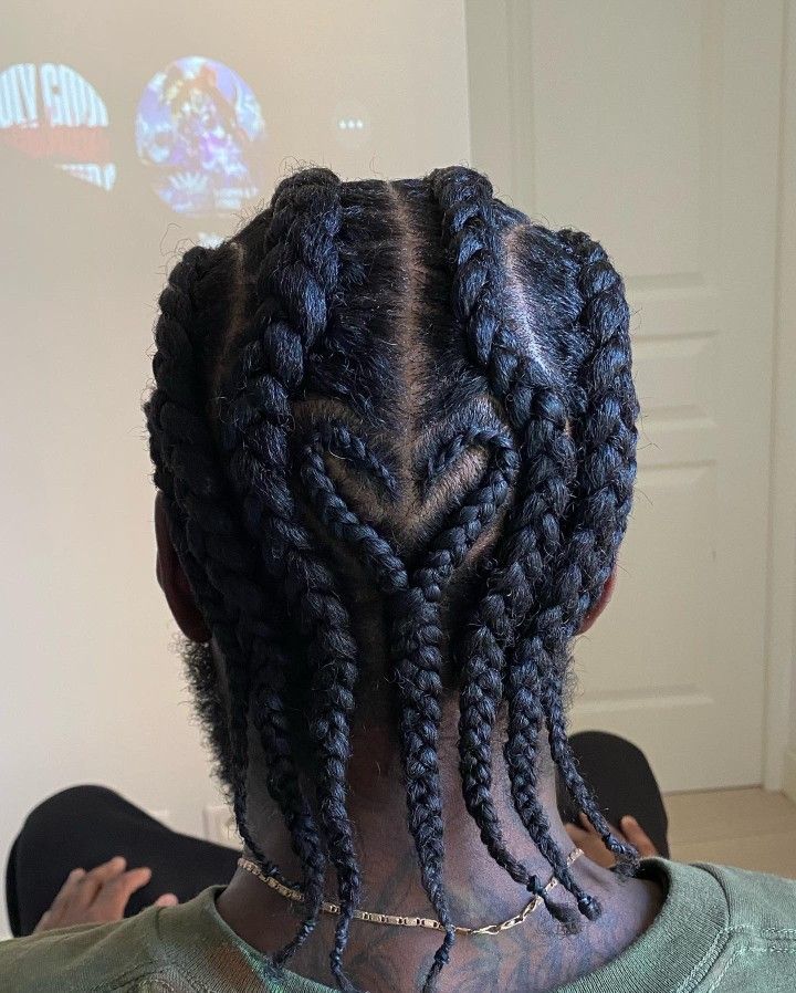 the back of a woman's head with large braids