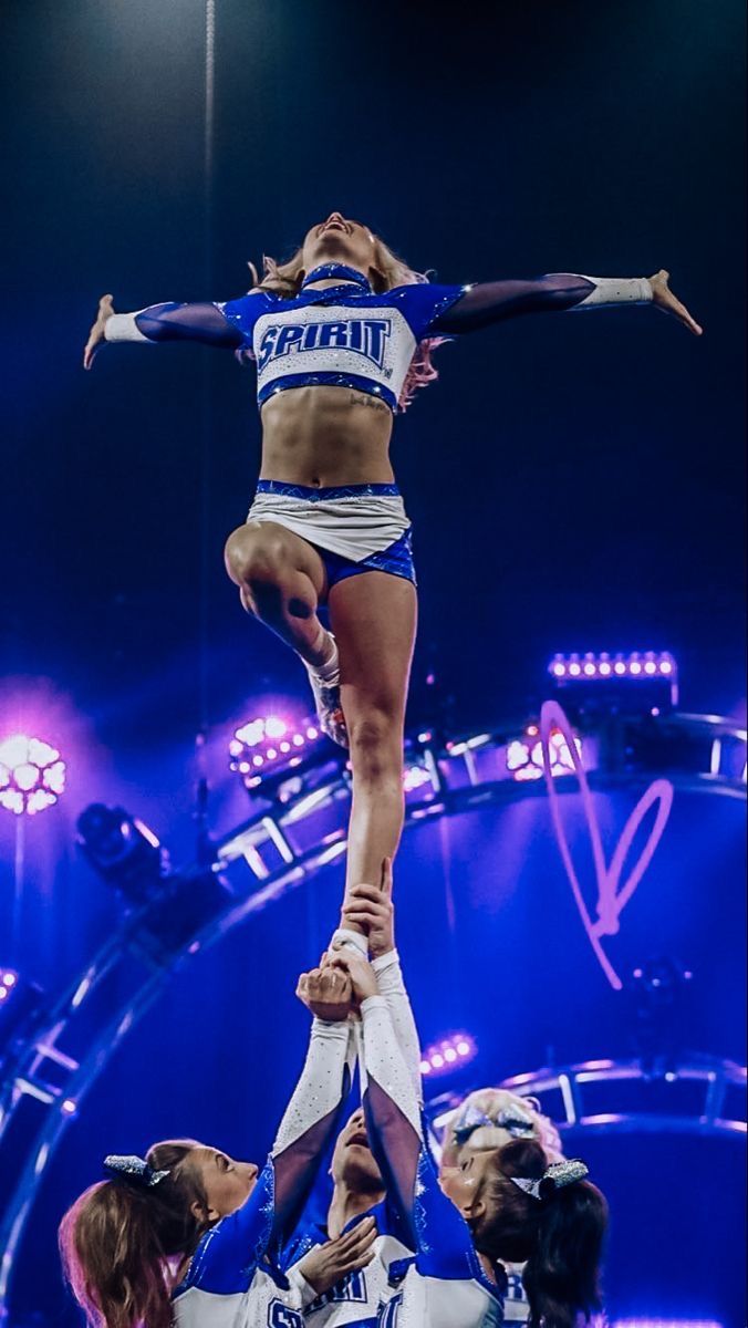 the cheerleaders are doing tricks for the crowd