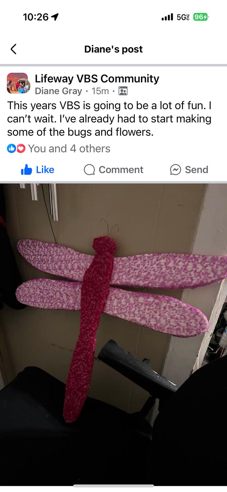 a pink dragonfly sitting on top of a chair