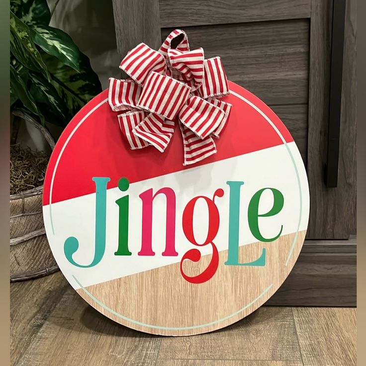 a wooden sign that says jungle with a bow on the front and side of it