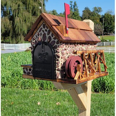 a mailbox made out of wood and stone