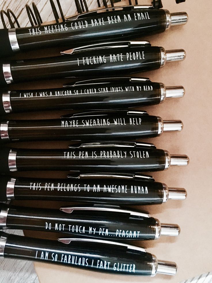 a bunch of pens that are sitting on top of a table with writing on them