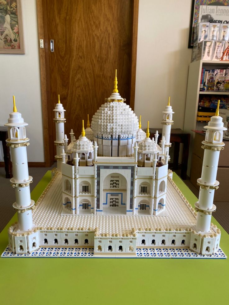 a lego model of a white building with yellow spires