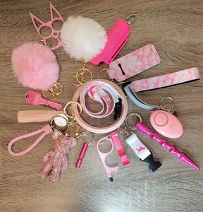 a collection of pink and white items on top of a wooden table next to a pair of scissors