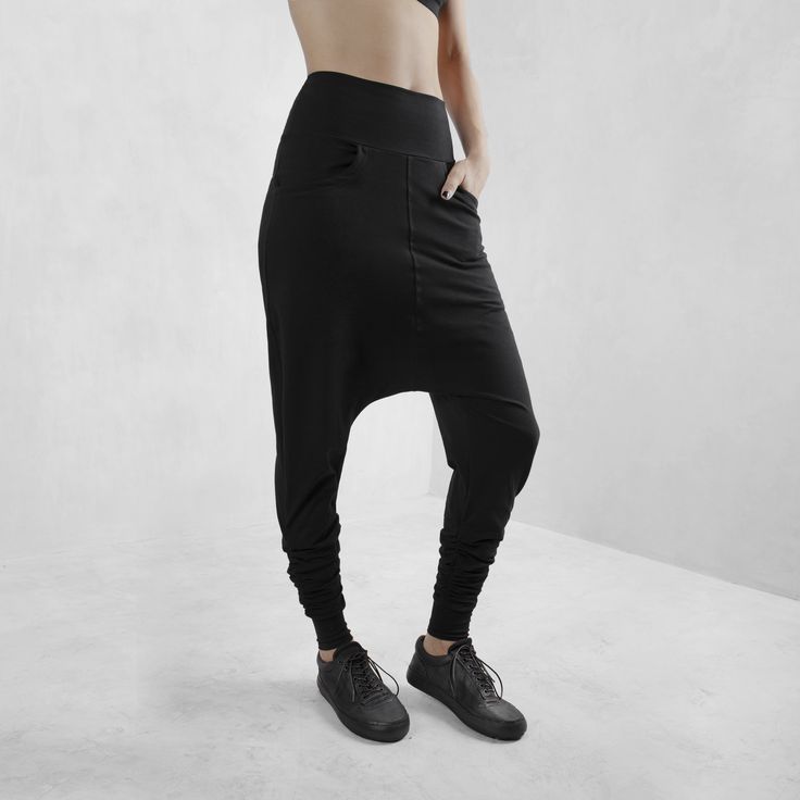 Edgy, cool streetwear style, black harem pants made from certified organic cotton with 10% lycra for comfort, fit and durability. These have a comfy set of side pockets, and a loose fit around the hips and extra volume at the ankle making these the perfect pair of pants for any body type or yoga, lounging, or night life. Totally versatile - create your look based on your need or situation. This cut flatters every body type with a relaxed, edgy, streetwear fit. Look fly AF but basically wearing y Sporty Harem Pants With Loosely Fitted Hips, Baggy Wide Leg Harem Pants For Athleisure, Relaxed Fit Full-length Harem Pants For Streetwear, Baggy High Waist Hip Hop Sweatpants, Baggy Wide Leg Harem Pants Hip Hop Style, Baggy Wide Leg Hip Hop Harem Pants, Baggy Full-length Hip Hop Pants, High Waist Baggy Hip Hop Sweatpants, Black Cotton Harem Pants For Streetwear