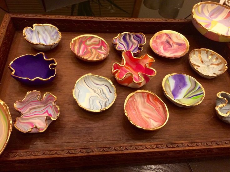 a wooden tray topped with lots of different colored dishes