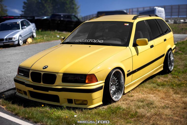 a yellow car parked on the side of a road