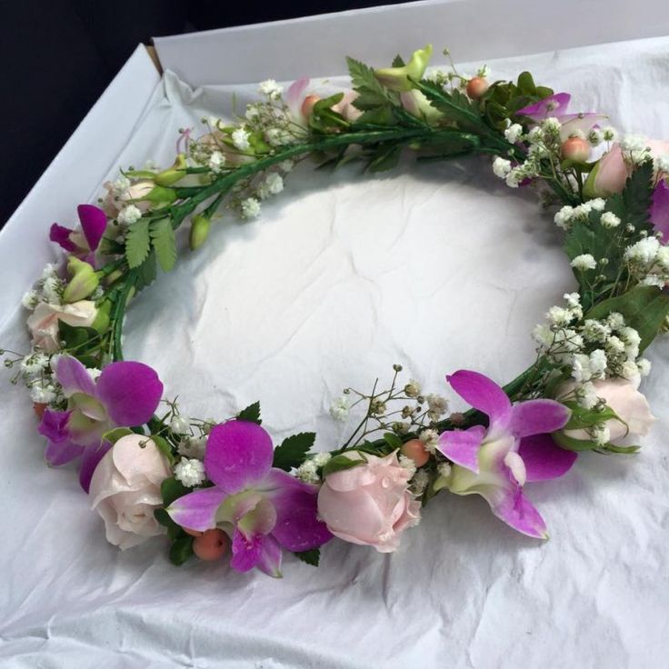 a white box with flowers and greenery on it