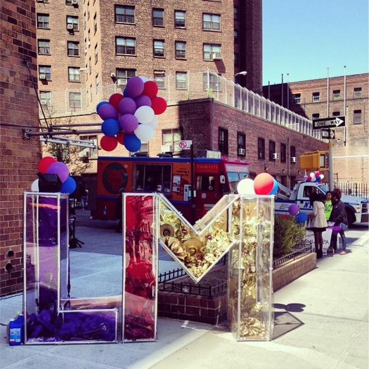 some balloons are in the shape of letters and numbers on a city street side walk