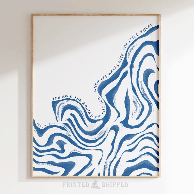 a blue and white painting hanging on the wall