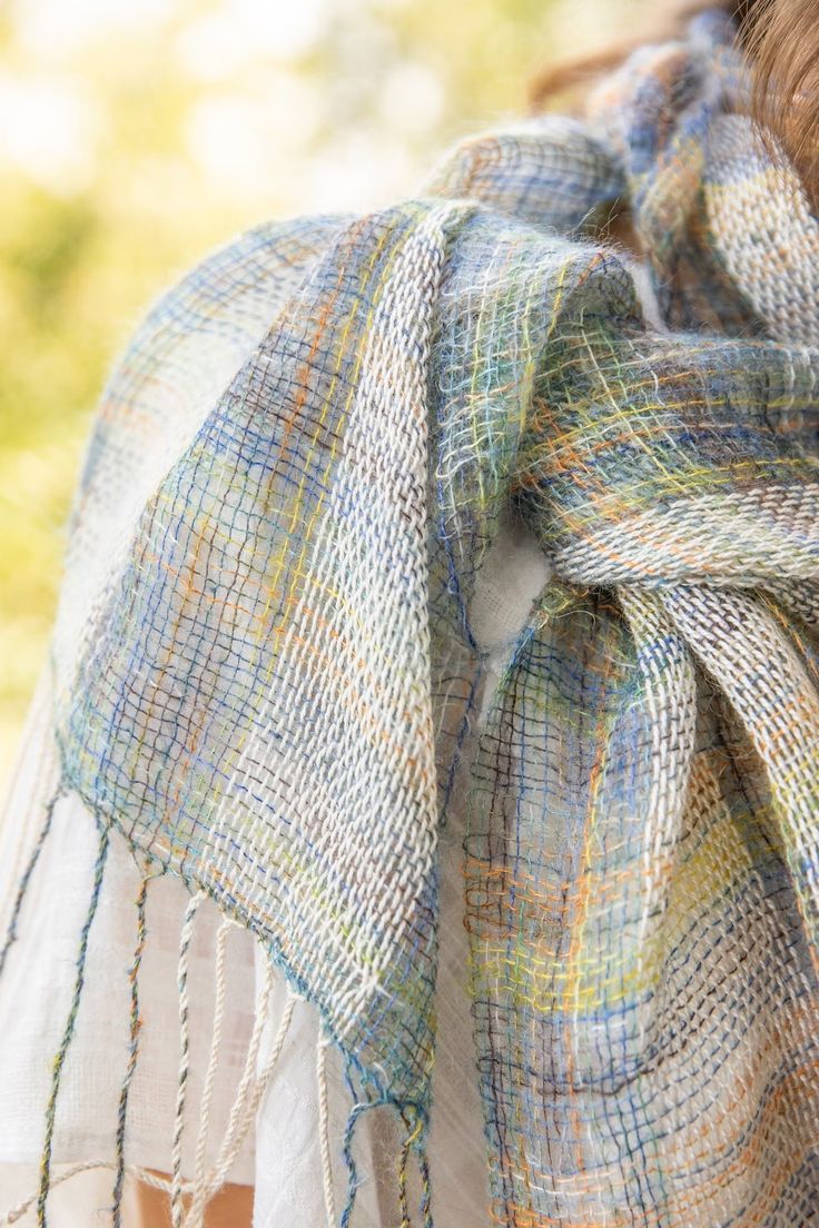 a close up of a person wearing a plaid scarf