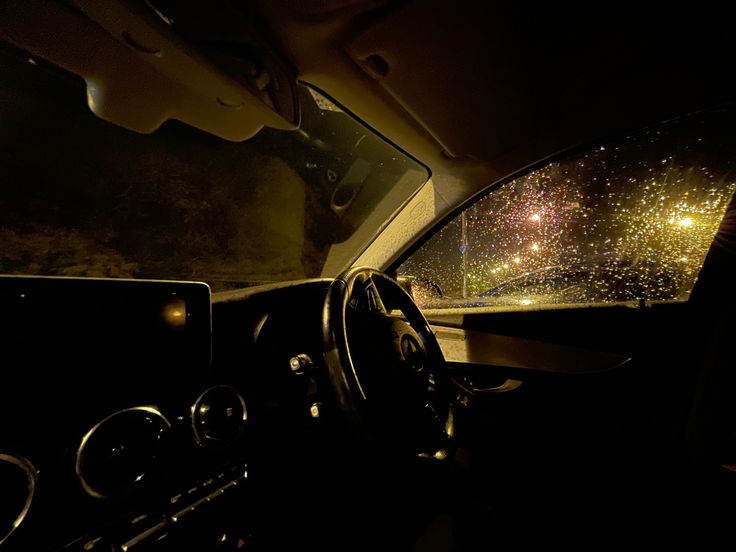 the inside view of a car driving at night with stars in the sky and on the dashboard