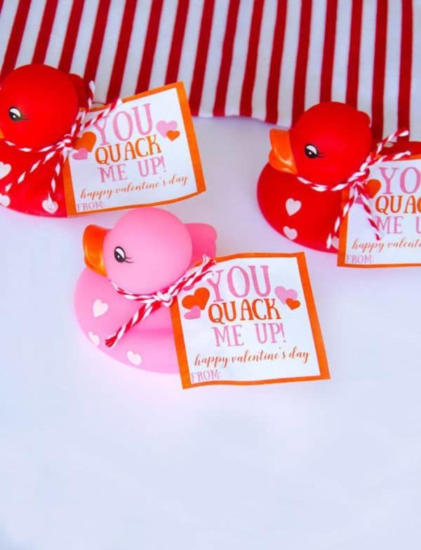 three valentine's day gift tags with rubber ducks on them sitting on a table