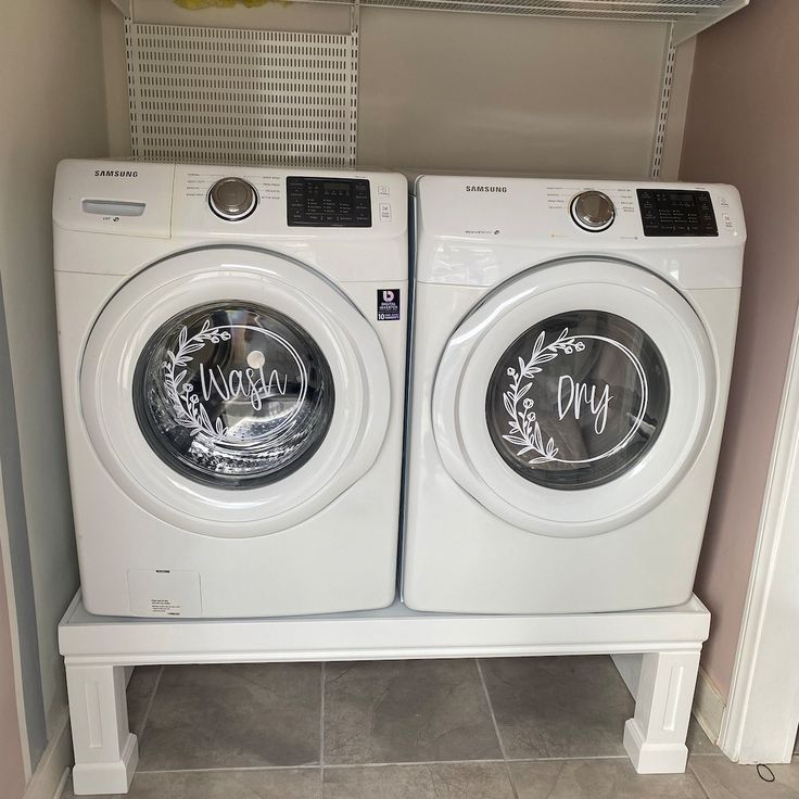 two washers sitting side by side in a room