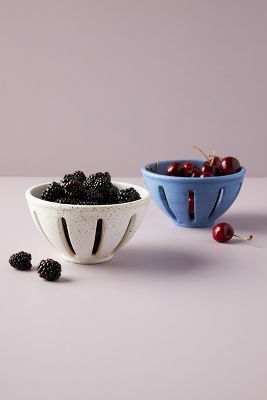 two bowls filled with blackberries next to each other