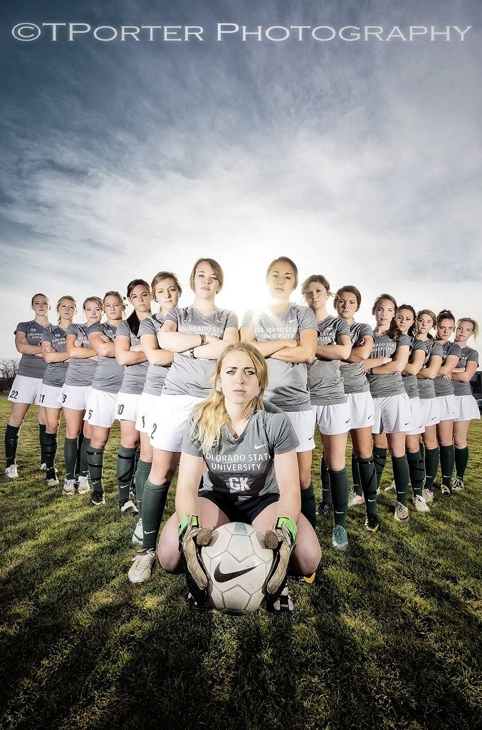 a group of women soccer players posing for a photo with the ball in front of them