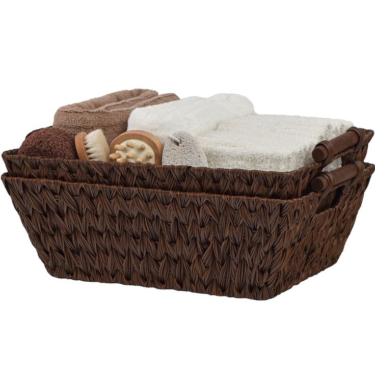 a brown basket filled with towels and other items