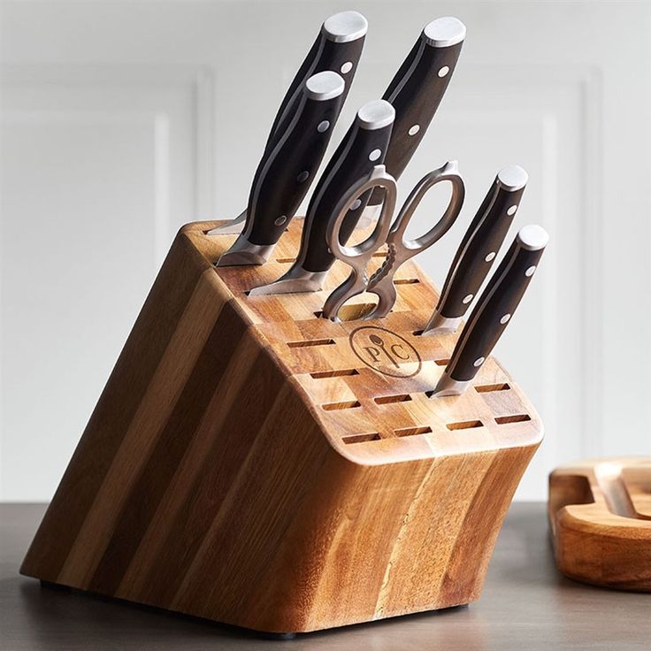 a wooden block with scissors and knives in it