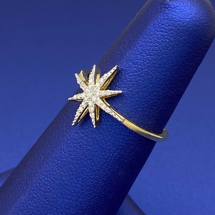 a gold ring with a star on it